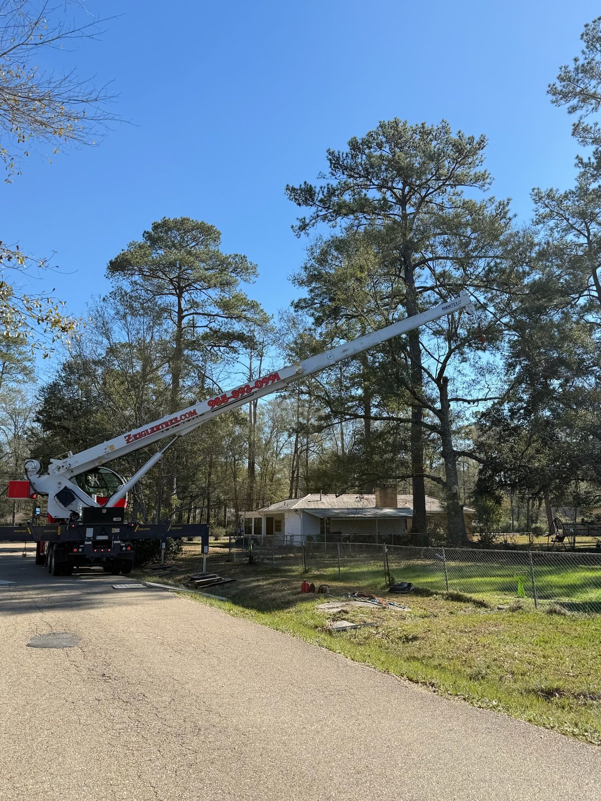 Bucket truck positioned for tree work on a residential street